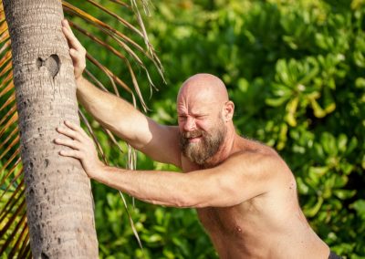Touch,Florida,Man,Pushing,Down,A,Palm,Tree