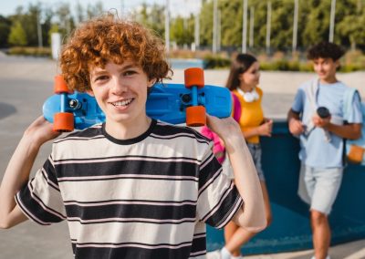 Smiling,Redhead,Curly,Teen,Boy,In,Sporty,Casual,Outfit,Holding