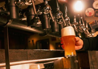 Bartender’s,Hand,Holds,Glass,Of,Light,,Cold,,Refreshing,Lager,Beer.