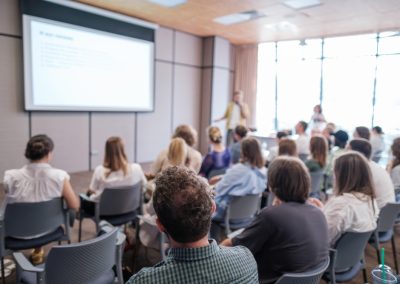 Attendees,Sit,Attentively,As,Speaker,Presents,During,Business,Conference.,Bright,