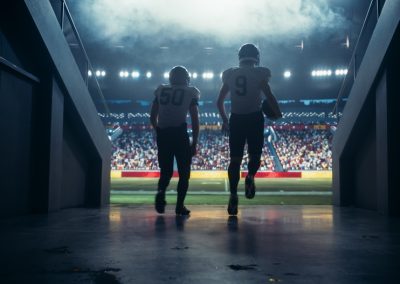 Diverse,Professional,American,Football,Players,Running,Out,Of,The,Stadium