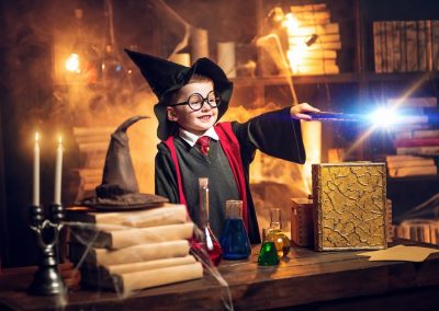 Small,Wizard,In,Glasses,And,Wizard’s,Hat,Holding,Magic,Wand.
