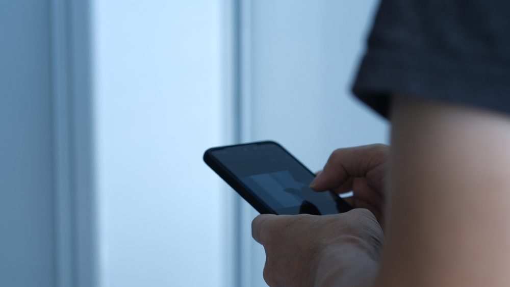 A,Man,Is,Typing,On,A,Smartphone,Secretly,In,The