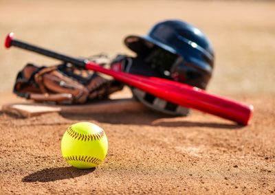 Close-up,Of,Optic,Yellow,Softball,On,Red,Dirt,Infield,With