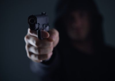 Robber,With,Gun,Aiming,Into,Camera.,Man,In,Hood,Threatens