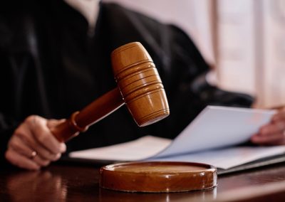 Wooden,Gavel,Held,By,Experienced,Female,Judge,Over,Sounding,Block