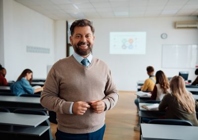 Happy,Professor,In,Lecture,Hall,At,The,University,Looking,At