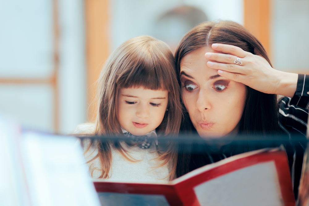 Surprised,Mom,And,Happy,Daughter,Reading,A,Book,Together.,Mother