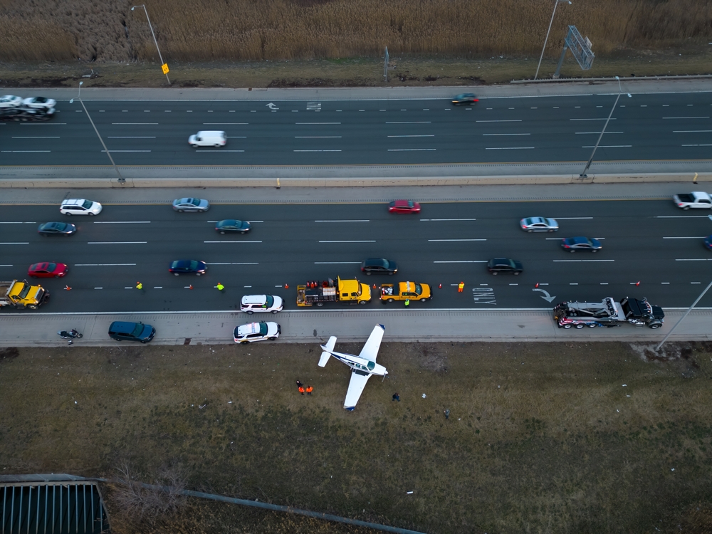 Emergency,Airplane,Landing,On,Highway.,Above,Wide,Drone,Shot
