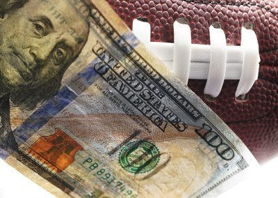 One,Hundred,Dollar,Bill,On,An,American,Football