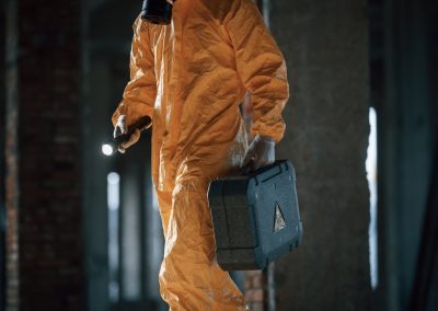 Holding,Case,And,Flashlight.,Man,Dressed,In,Chemical,Protection,Suit