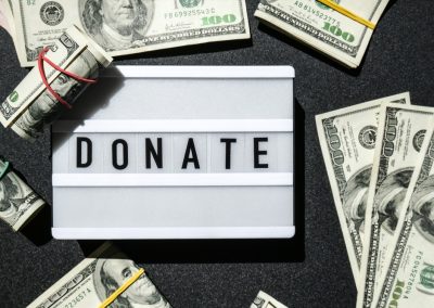 Lightbox,Board,With,Word,Donate,In,Black,Letters,Around,Us