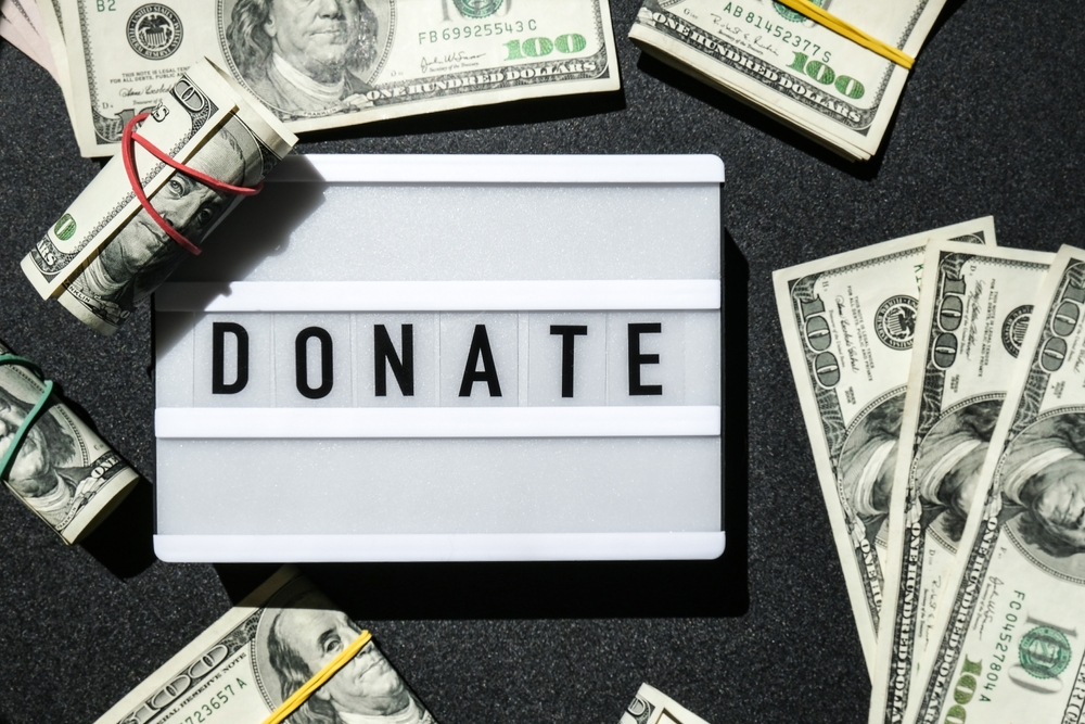 Lightbox,Board,With,Word,Donate,In,Black,Letters,Around,Us