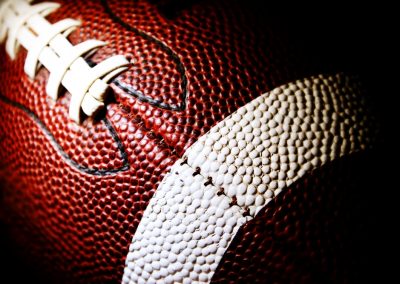 Close,Up,Of,An,American,Football,Against,A,Black,Background