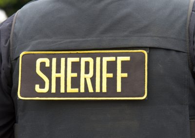 Close,Up,On,Sheriff,Letters,On,Back,Of,Flack,Jacket.