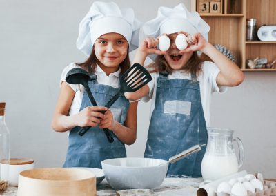 Two,Little,Girls,In,Blue,Chef,Uniform,Have,Fun,While