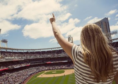 Woman,Standing,And,Cheering,At,A,Baseball,Game