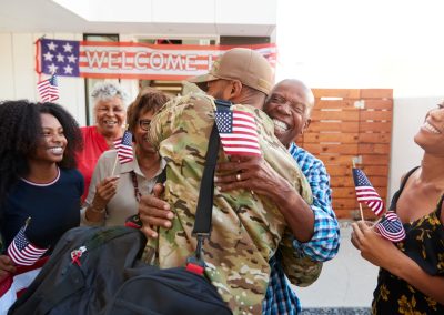 Millennial,Black,Soldier,Returning,Home,To,His,Family,,Embracing,Grandfather,