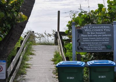 Boardwalk,Entrance,For,Cape,Canaveral,Beach,With,Trash,Bins,To