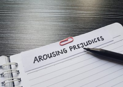 Arousing,Prejudices,Writting,On,Table,Background.