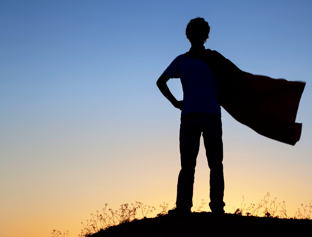 Boy,Playing,Superheroes,On,The,Sky,Background,,Silhouette,Of,Teen
