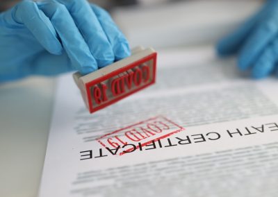 Doctor,Puts,Stamp,On,Covid-19,Death,Certificate.,Pandemic,Mortality,And