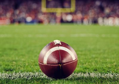 A,Closeup,Of,An,American,Football,On,A,Green,Field,