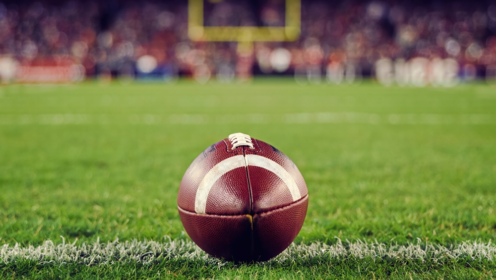A,Closeup,Of,An,American,Football,On,A,Green,Field,