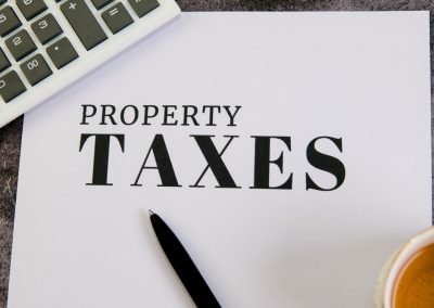 A,Document,On,Property,Taxes,Sits,By,A,Calculator,And
