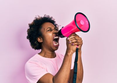 African,American,Woman,With,Afro,Hair,Screaming,With,Megaphone,Over
