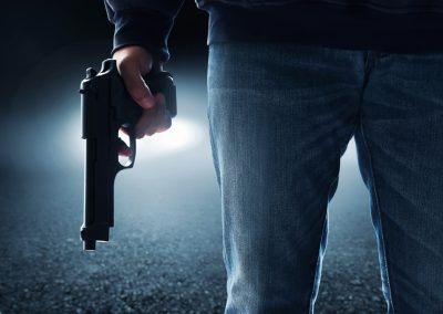 Hooded,Man,Holding,A,Gun,On,Urban,City,Alley,Street