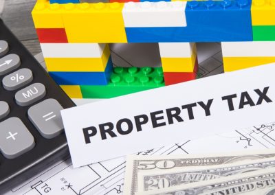 Inscription,Property,Tax,With,Small,House,Made,Of,Colorful,Toy