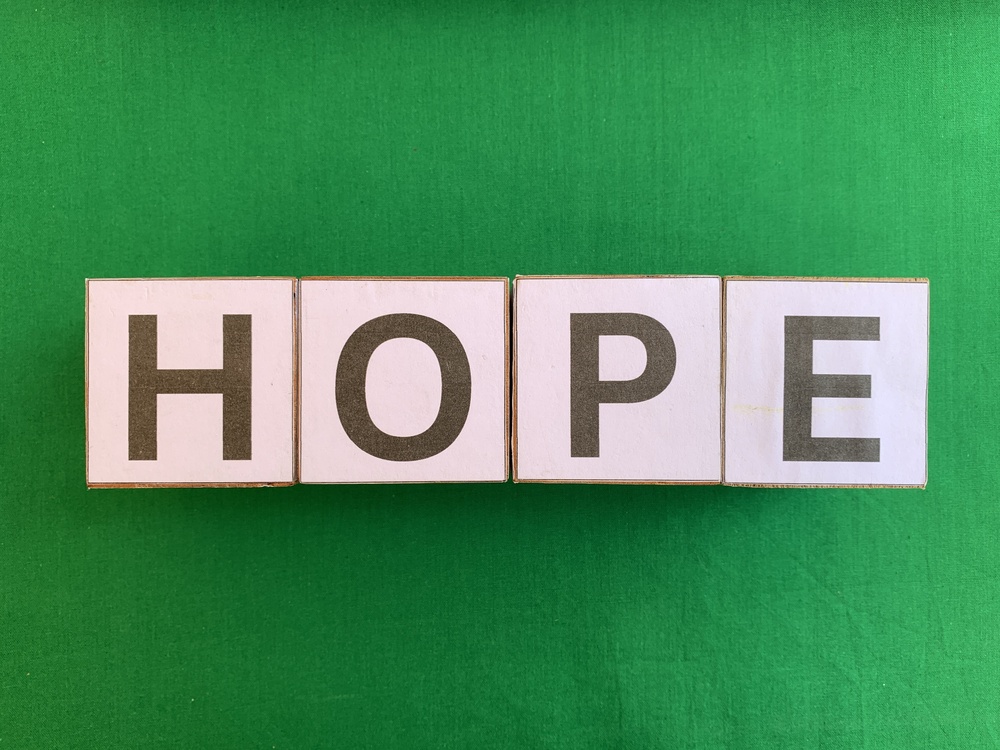 The,Word,Hope,Spelled,On,White,Cardboard,Blocks,Against,A