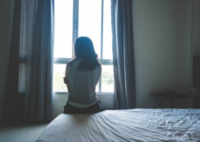 Florida’s AG Just Caught 12 Men Who Paid to Meet With Children at a Hotel Woman,Sitting,On,Bed,In,Room,With,Light,From,Window