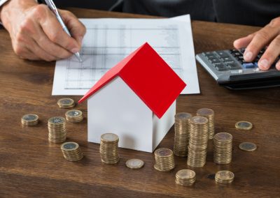 Ron DeSantis Blew a Gasket Over How the Wall Street Journal Referred to His Property Tax Relief Plan Cropped,Image,Of,Businessman,Calculating,Tax,By,Model,House,And