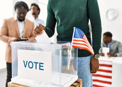 New Poll Shows Who FL-14 Voters Back When They Learn Which Republican Never Abandoned Trump Young,American,Voter,Man,Smiling,Happy,Putting,Vote,In,Voting