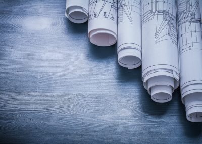 Copyspace,Image,Rolls,Of,Blueprints,On,Blue,Board.