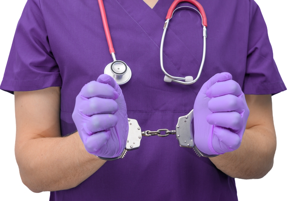 Doctor,Arrested,,Hands,In,Police,Handcuffs,Close,Up