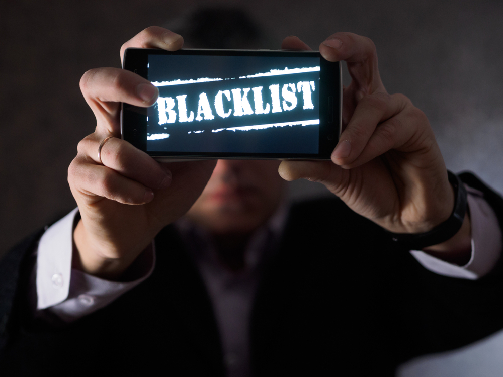 The,Man,Is,Holding,A,Smartphone,In,His,Hands,,Facing