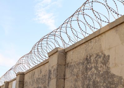 Barbed,Wire,Fence,On,Top,Of,A,Wall