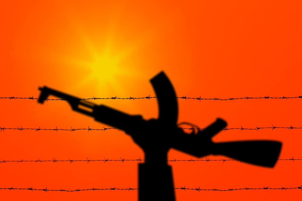 Palestine,And,Israel,Conflict.,Hand,Holding,Gun,Over,Barbed,Wire.