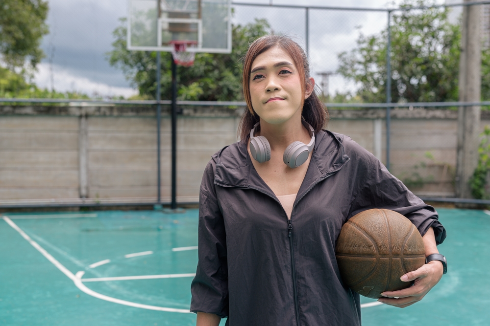 Portrait,Of,A,Fit,Transgender,Woman,Standing,On,Outdoor,Basketball