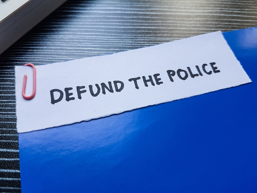 The,Writting,Defund,The,Police,On,Table,Background.