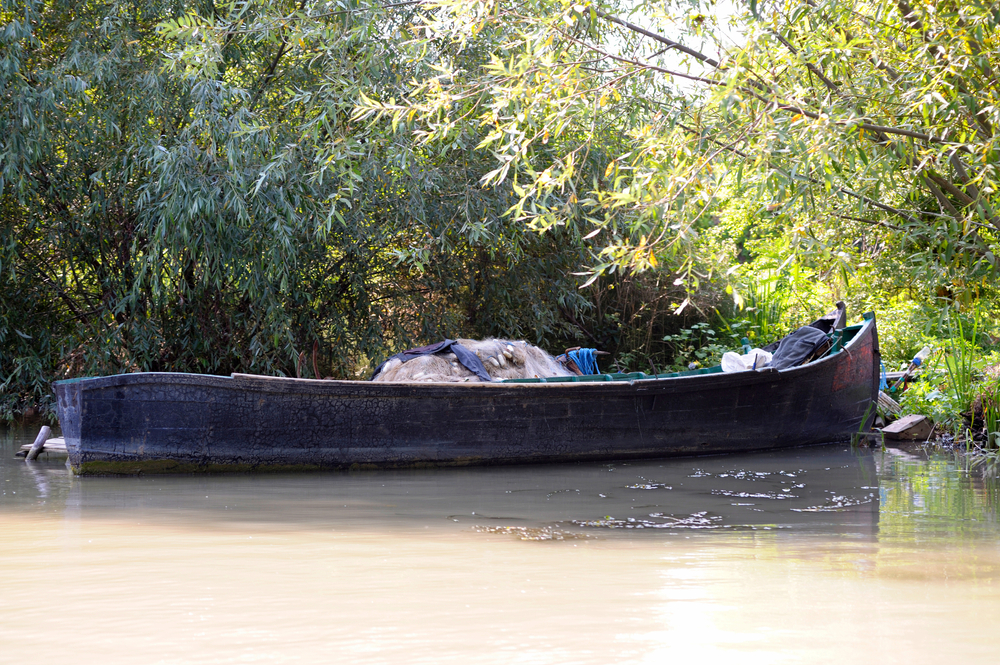 An,Old,Wooden,Motorboat,Loaded,With,Empty,Fishnets,Left,By