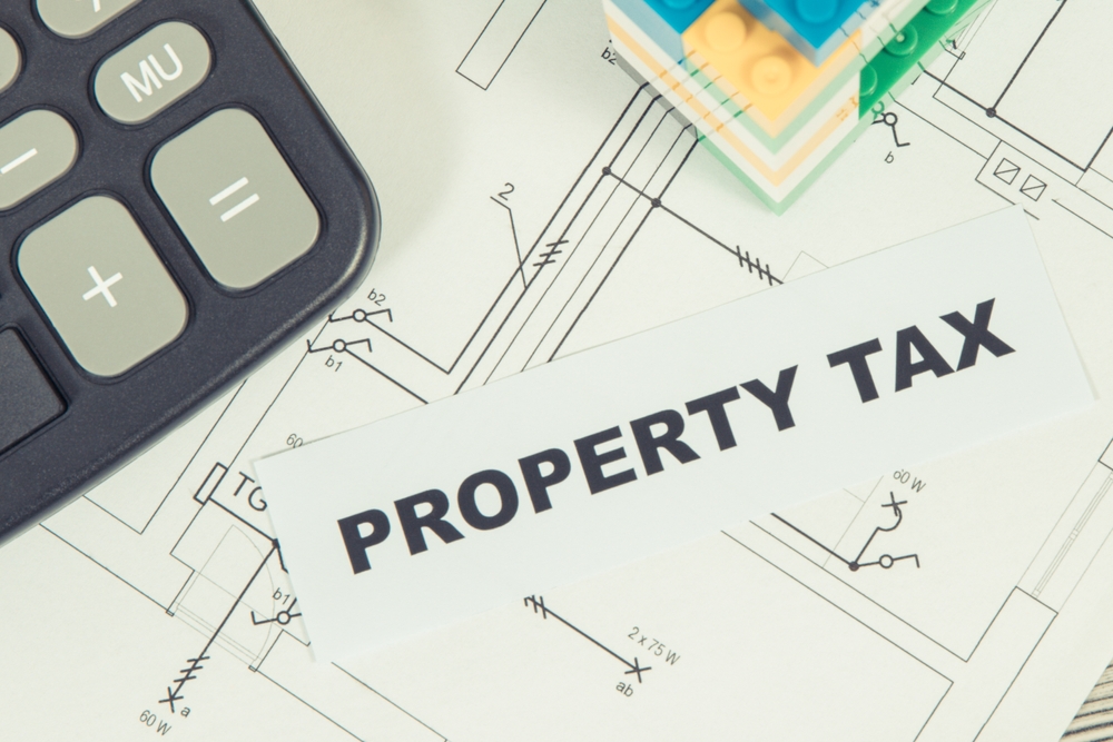Inscription,Property,Tax,With,Small,House,Made,Of,Colorful,Toy