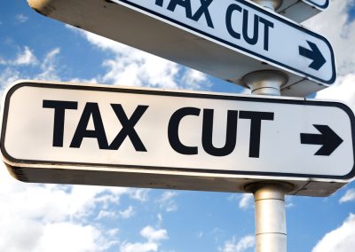 Tax,Cut,Direction,Sign,On,Sky,Background