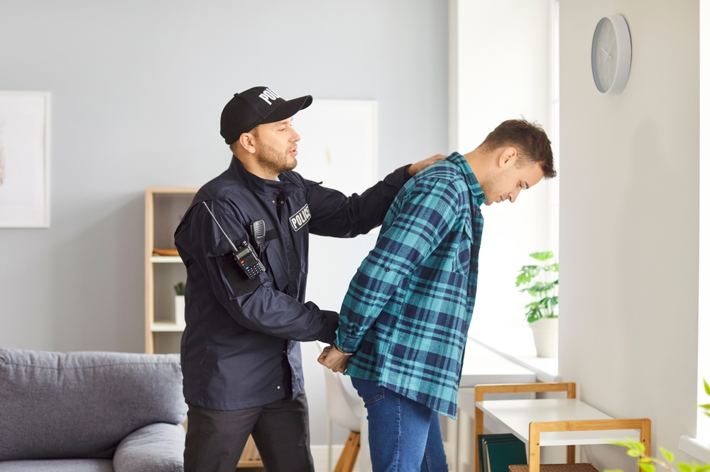 Policeman,Arrests,A,Man,Suspect,Or,Prisoner,,Securing,Handcuffs,As
