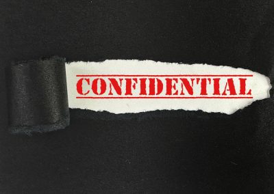 Florida’s AG Caught Democrats Leaking a Grand Jury Report Right Before the Election Text,Of,Confidential,On,White,Paper,Behind,The,Torn,Black