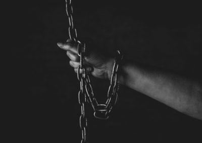 Florida’s AG Called It a Rolling Dungeon and Now One Suspect Faces the Death Penalty A,Person,With,Their,Fingers,Gripping,A,Metal,Chain,In