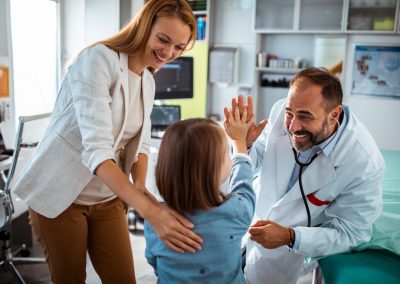 Joyful,Pediatrician,Giving,High-five,To,Young,Girl,During,Medical,Examination